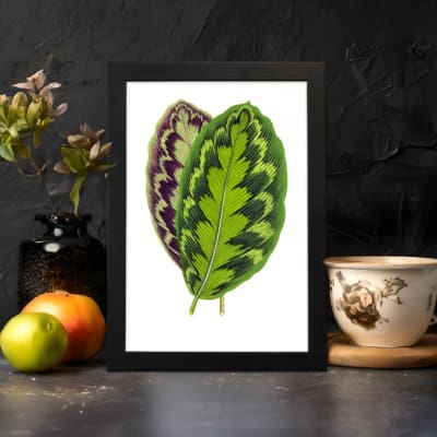 Infidu Vibrant Green and Purple Leaf Vintage Wall Art featuring bright green and purple leaves with natural detailed patterns. displayed on the wall
