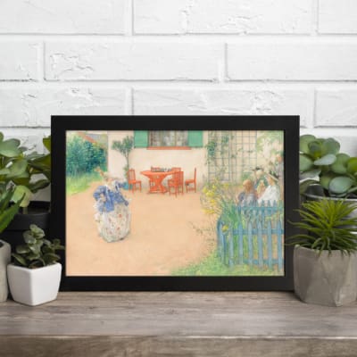 Infidu Peaceful Garden vintage wall art showcasing colorful flowers, outdoor table, and green plants in soft pastel tones with a black frame. displayed on the wall
