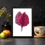 Vintage wall art featuring two overlapping leaves in red and purple on a white background with a black frame. displayed on the wall