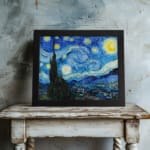 Vincent van Gogh’s The Starry Night vintage wall art shows swirling blue sky, bright yellow stars, a crescent moon, a tree silhouette, and a village. displayed on the wall
