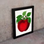 Vintage red apple wall art with green leaves on a white background, perfect for kitchen or dining room decoration. displayed on the wall