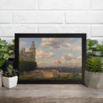 Vintage wall art of a coastal town with sailing ships, historic buildings, and soft blue sky by Infidu. displayed on the wall