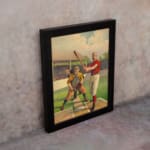 Infidu vintage wall art featuring a classic baseball scene with a batter, catcher, and judge in period uniforms on a vibrant field. displayed on the wall in a black frame
