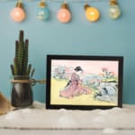 Infidu vintage wall art featuring a graceful Japanese woman in a traditional kimono with intricate patterns and soft colors. displayed on the wall art in a black frame