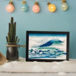 Vintage wall art of Mount Fuji with white cranes and flying birds in a peaceful nature scene. displayed on the wall
