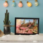 Vintage garden scene with pink flowers, classical figures, and elegant background from Infidu wall art collection. displayed on the wall