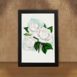 Vintage white rose wall art with green leaves and soft blue background. displayed on the wall