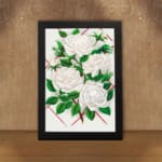 Vintage art of white roses with green leaves and red geometric background, framed for classic elegance. displayed on the wall