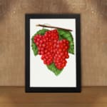 Vintage wall art of red grapes on a vine with green leaves and a white background, framed in black. displayed on the wall