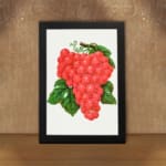 Vintage wall art of red grapes with green leaves on a white background. displayed on the wall