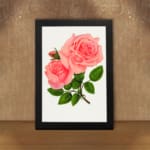 Vintage pink rose wall art with two full-bloom roses and green leaves on white background. displayed on the wall