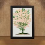 Infidu vintage wall art of a delicate pink blossom tree with green leaves and a white background. displayed on the wall