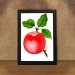 Vintage red apple wall art with green leaves on a white background. displayed on the wall