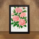 Vintage pink rose wall art with green leaves and trellis design. displayed on the wall