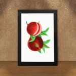 Vintage wall art featuring ripe red peaches with green leaves and a clean white background. displayed on the wall