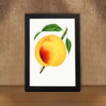 Ripe golden peach with green leaves on a white background, vintage wall art. displayed on the wall