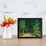 Vintage wall art of a forest path with tall green trees and earthy tones by Infidu. displayed on the wall
