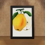 Vintage wall art of a yellow pear with a sliced half, green leaves, and a white background in a botanical illustration style. displayed on the wall