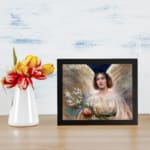 Infidu Serene Angelic Woman vintage wall art print showing a peaceful woman in a white gown with flowers and glowing background. displayed on the wall