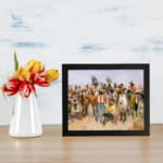Vintage wall art of cowboys and Native Americans in a desert scene with warm earthy colors and a painterly style. displayed on the wall