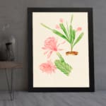 Vintage wall art with pink flowers and green cactus stems in a brown pot, set against a beige background with a clean black frame. displayed on the wall