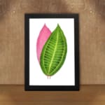Vintage wall art featuring a green and pink leaf print with detailed veins and a white background. displayed on the wall