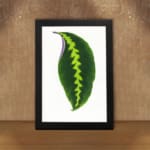 Vintage wall art showcasing a bold green leaf with a yellow-green zigzag pattern and purple edge, framed in black for an elegant finish. displayed on the wall