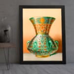 Vintage wall art featuring a decorative green vase with floral and geometric patterns, framed in black. displayed on the wall