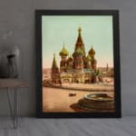 Vintage art print of Saint Basil’s Cathedral with colorful domes, a horse-drawn carriage, and a black frame displayed on the wall