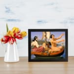 Vintage wall art of an elegant boat scene with people, floral details, and calm water. displayed on the wall