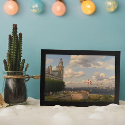 Vintage wall art of a coastal town with sailing ships, historic buildings, and soft blue sky by Infidu. displayed on the wall