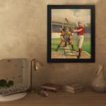 Infidu vintage wall art featuring a classic baseball scene with a batter, catcher, and judge in period uniforms on a vibrant field. displayed on the wall in a black frame