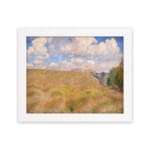 Vintage wall art of a golden grass field under a blue sky with white clouds and trees on the side hung on the wall