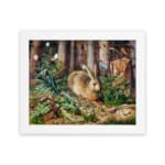Vintage wall art of a brown rabbit sitting in a lush green forest with trees and plants in the background. hung on the wall