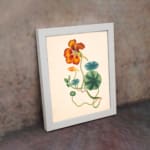 Vintage floral wall art with orange-red flower and green twisting vines on a beige background. displayed on the wall