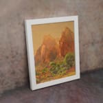 Infidu Rustic Mountain Scene vintage wall art showing mountains with reddish-brown cliffs, green trees, and a golden-yellow sky. displayed on the wall