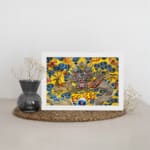 Infidu vintage wall art featuring a majestic dragon in gold, red, and silver tones, surrounded by blue clouds and fiery red flames on a vibrant yellow background. displayed on the wall art in a white frame