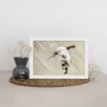 Infidu vintage wall art featuring a graceful hummingbird in flight against a soft brown background with soothing, natural tones. displayed on the wall art in a white frame
