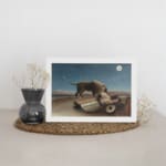 Infidu vintage wall art featuring a mysterious scene of a lion standing beside a sleeping person under a full moon in a serene, dreamlike landscape. displayed on the wall art in a white frame