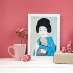 Vintage wall art of a graceful Japanese woman in a soft-toned kimono holding a fan. displayed on the wall