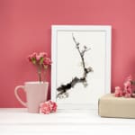 Minimal blossom branch vintage wall art in black and light brown on white background. displayed on the wall