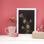 Vintage floral wall art with pink and purple flowers on black background by Infidu displayed on the wall