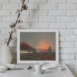 Vintage wall art showing a dramatic ocean sunset with tall waves, sailing ships, glowing cliffs, and a cloudy sky. displayed on the wall