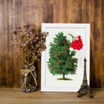 Botanical illustration of a red berry tree with green leaves and vivid red berries on a white background. displayed on the wall