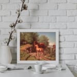 Two horses in a countryside setting with trees, grass, and soft sky tones, framed in white – vintage wall art by Infidu. displayed on the wall