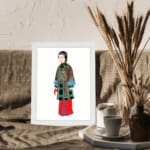 Vintage wall art of a cultural figure wearing a brown robe with green and blue details, red pants, and a plain white background. displayed on the wall