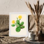 Vintage wall art featuring a cactus with yellow flowers, set against a light beige background with a white frame. displayed on the wall