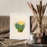 Infidu Vintage Cactus & Yellow Flower Wall Art showcasing a vibrant cactus plant with a yellow flower, framed in white. displayed on the wall