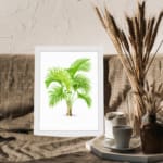 Vintage wall art featuring a green palm plant with curved leaves, framed in white, adds a fresh tropical feel to any room. displayed on the wall