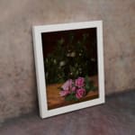 Infidu vintage wall art featuring delicate pink roses with lush green leaves on a rustic wooden background. displayed on the wall art in a white frame